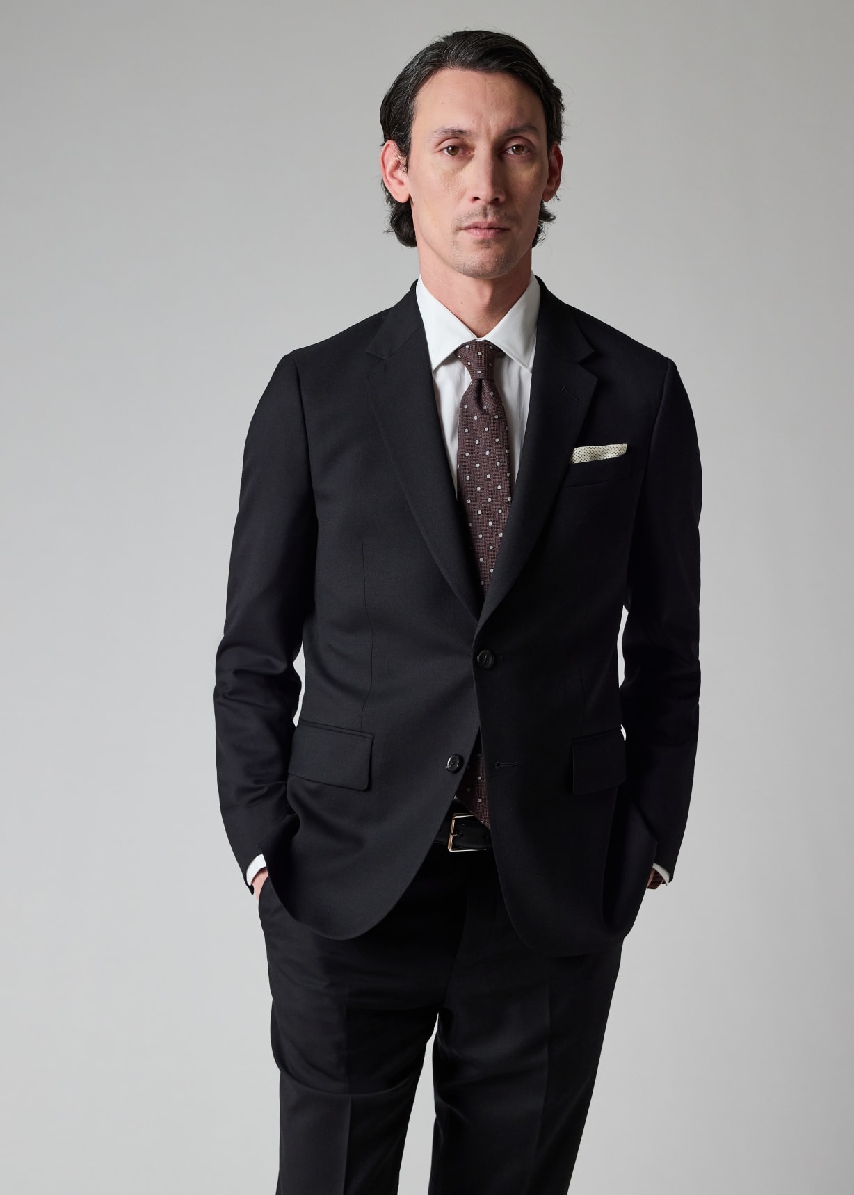 Male model wearing a black Paul Smith Soho Suit To Travel In.